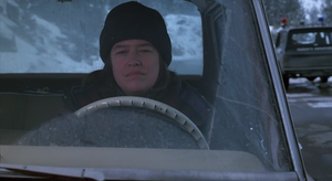 Annie driving in her car, a 1974 Jeep Cherokee.