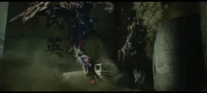 Lockdown gets kicked down in the wall by Optimus Prime.