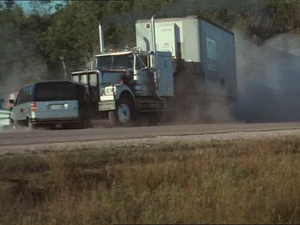 The truck rams into the SUV as it exits the junkyard.