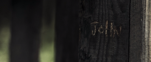John's name carved into the front porch railing.