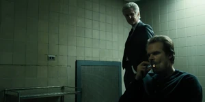 Brenner questioning Hopper who promises to reveal Eleven's location in exchange for being allowed to rescue Will and Brenner not harming Mike, Dustin, and Lucas.