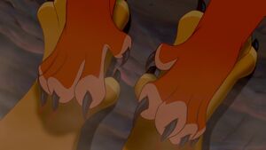 Scar taking hold of Mufasa's paws and digging his claws into them.