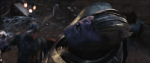 Thanos is knocked back by the attack.