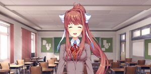 Monika in her school happily talking to the player.