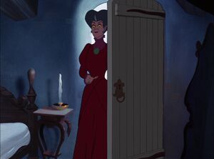 Lady Tremaine glaring at Cinderella before she traps her in the attic.