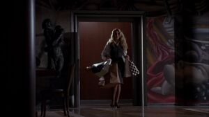 Alicia returning to Grissom's penthouse after a shopping spree.