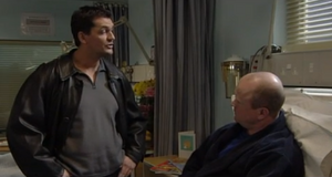 Phil is threatened and taunted by Dan over being shot (2001).