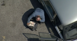 Phil is told by Dan via phone to show him the ransom money in the bag (2001).