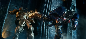Megatron being kicked out of the Ignition Chamber by Optimus Prime.