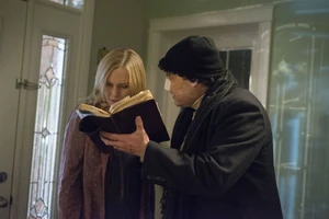 Kent showing Meg the book on the Clöyne