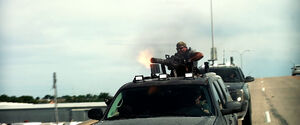 A Cemetery Wind member uses a minigun to shoot the Yeager family.