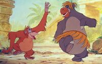 Louie dancing with a disguised Baloo.