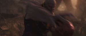 Thanos rips Iron Man's helmet off.