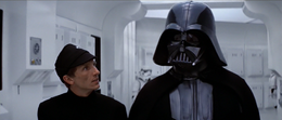 Vader listening to Commander Daine Jir's report.