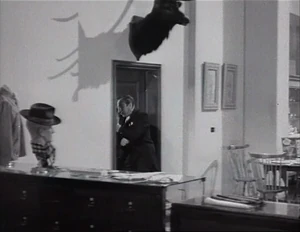 Grover charging at the door just as the 3 men open it for him