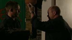 Phil Mitchell confronts his employee Garry Hobbs at the mechanic shop.