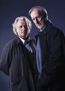 A publicity photo of Rutger Hauer as Kurt Barlow and James Cromwell as Father Callahan, respectively.