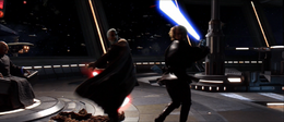 Dooku and Skywalker spin around each other about to clash blades.