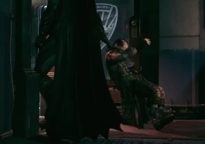 Batman dragging Mad Hatter to his cell.