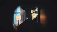 Persephone looks up to see Seamus, looking through a peephole.