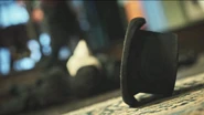 A shot of an unconscious Persephone in the background, with her hat in focus.