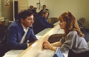 Alan is visited by Jenny in prison.