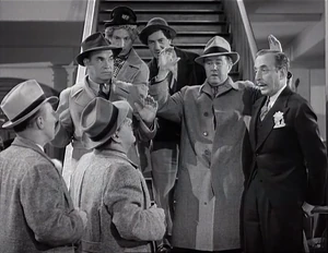 Grover trying in vain to keep the real killers from being arrested