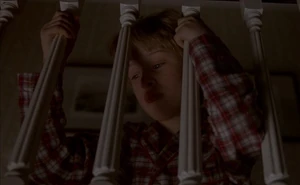 Henry peeking from behind banisters.