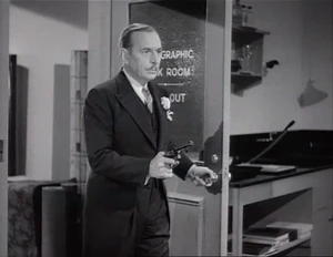 Grover holding Flywheel, Ravelli, and Wacky at gunpoint