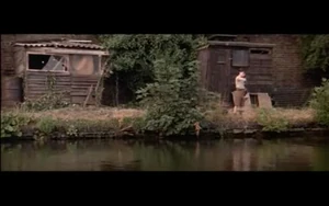 Pink about to drop the rat in the river.