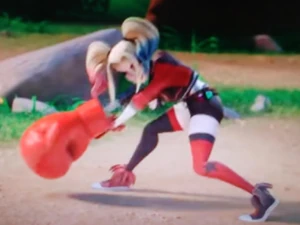 Harley Quinn is holding her weapon