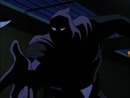 Ubu throwing a dagger at Batman