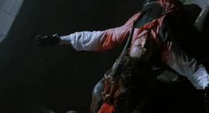 Top Dollar's body is impaled on the horns of a gargoyle.