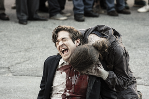 Sebastian being eaten alive by a Walker during a festival.