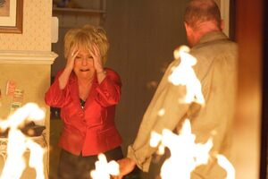 Phil sets The Queen Vic on fire in front of Peggy (2010).
