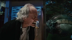 Carl Goodman as he mocks a piranha in the fish tank.