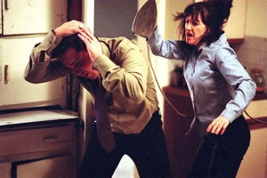 Trevor about to collapse on the floor after Little Mo finishes attacking him with an iron in self-defense.