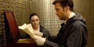 Dalton examining the incriminating documents.