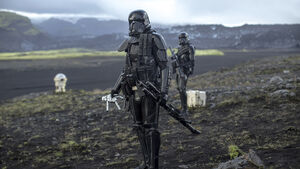 A Death Trooper holding a stormtrooper doll.