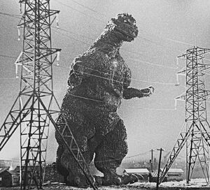 Godzilla is preparing to destroy the electric fence.