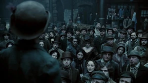 Mrs. Lovett and Sweeney watching an advertisement for Pirelli's Miracle Elixir.