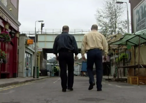 Phil and Grant observing their neighbourhood in Albert Square from the fictional borough Walford in East London.