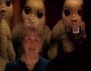 Blon (as Margret Blaine) reveals the Slitheen's plan to the Doctor
