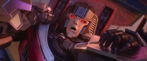 Starscream gloating and taunting D-16, while his vocal cords are damaged.