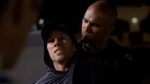 Animal being apprehended by Agent Morgan.