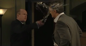 Phil chucks a drink over Dan's face (2001).