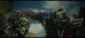 Lockdown about to kick Optimus Prime down in the wall back.
