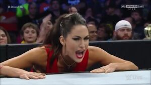 Brie Bella (at ringside), yelling the referee.