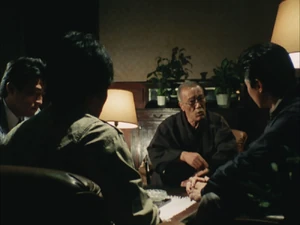 Omiya attending a meeting.