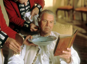 Cornwallis being shaved while reading a book.